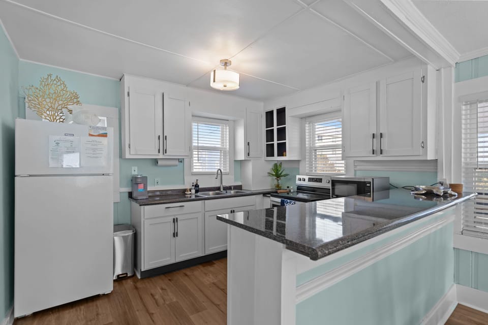 Fully equipped kitchen with modern appliances and natural light