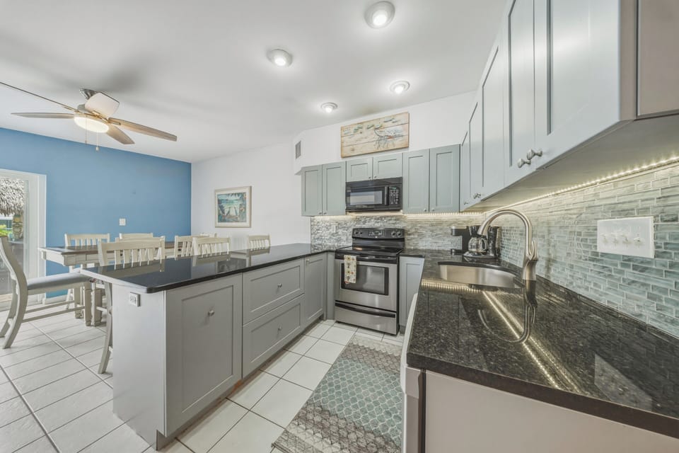 Prepare breakfast before a day on the water or enjoy a relaxed dinner at home in this bright, functional kitchen at your Key Colony Beach Florida Keys getaway.