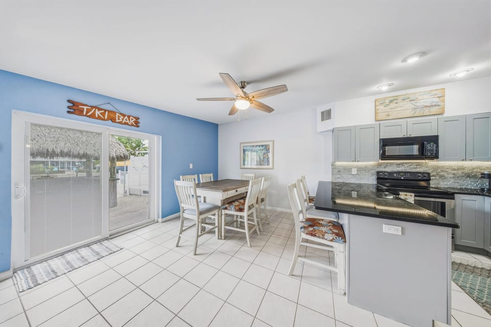 The dining area offers a table with seating for 6, plus additional bar seating for 3, making it easy for families and groups to gather for meals in comfort.