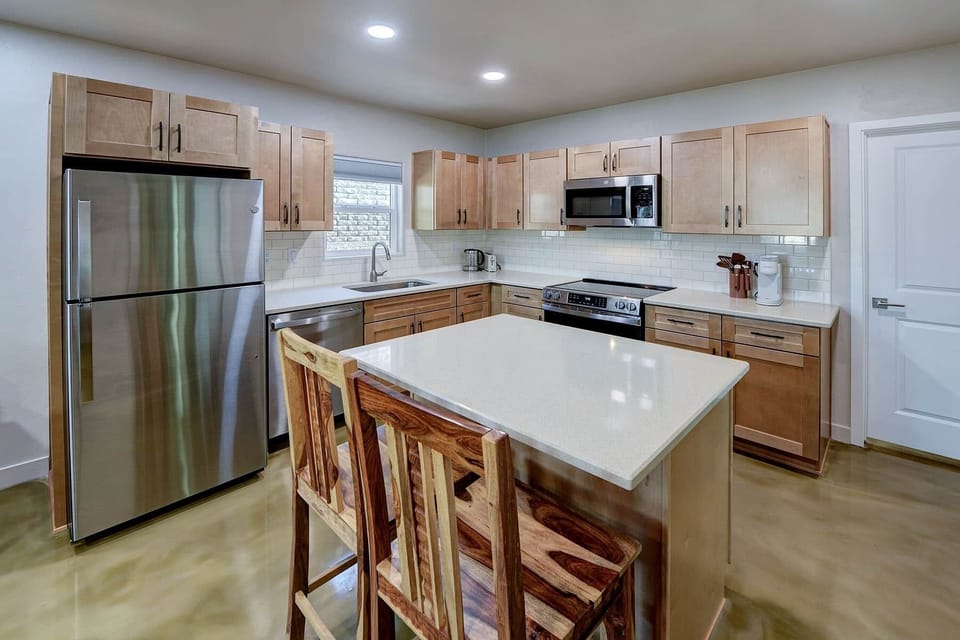 Roomy Kitchen with island and bar stools