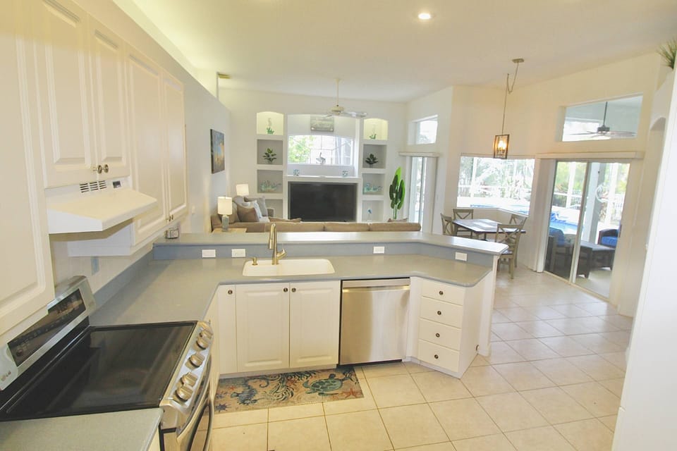 The large kitchen overlooks the family room and pool deck.