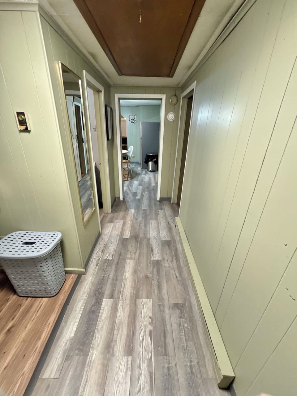 Laundry area is to the left (washer and dryer and hamper)