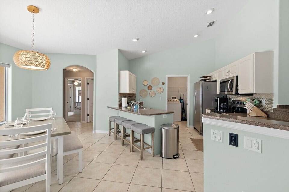 Fully equipped kitchen with dining space and bar seating for gathering together.