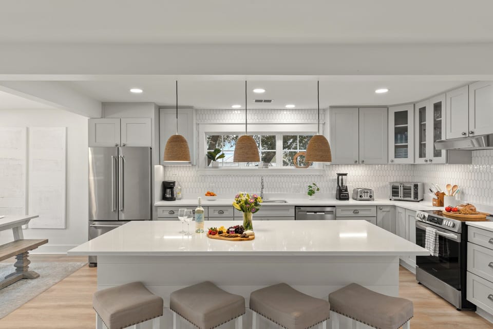 Clean lines, stylish woven pendant lights, and plenty of storage define this upscale kitchen.