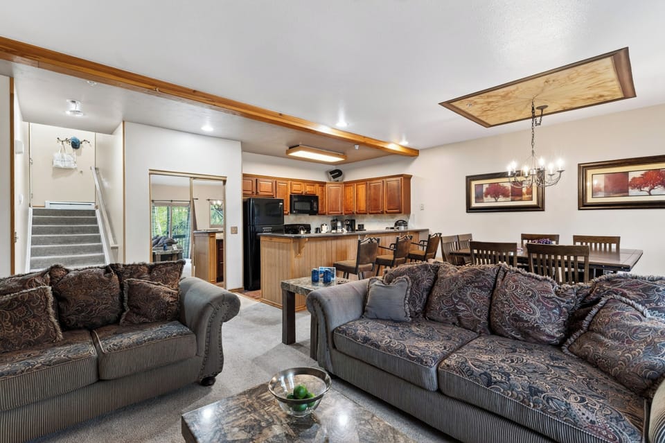 Cozy living room with a stone fireplace, queen sleeper sofa, and mountain-lodge charm.