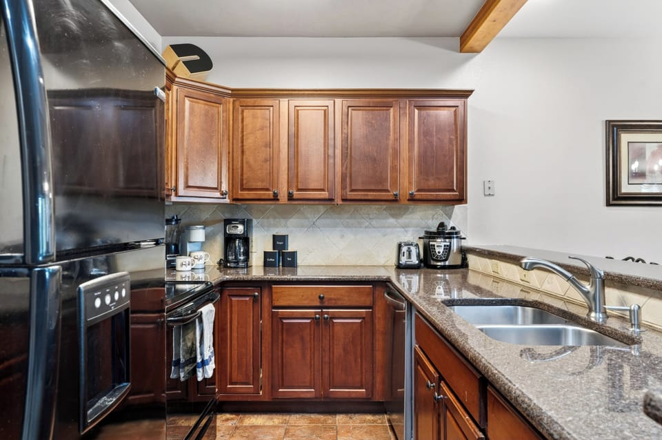 Spacious kitchen with breakfast bar seating and everything you need for easy group meals.