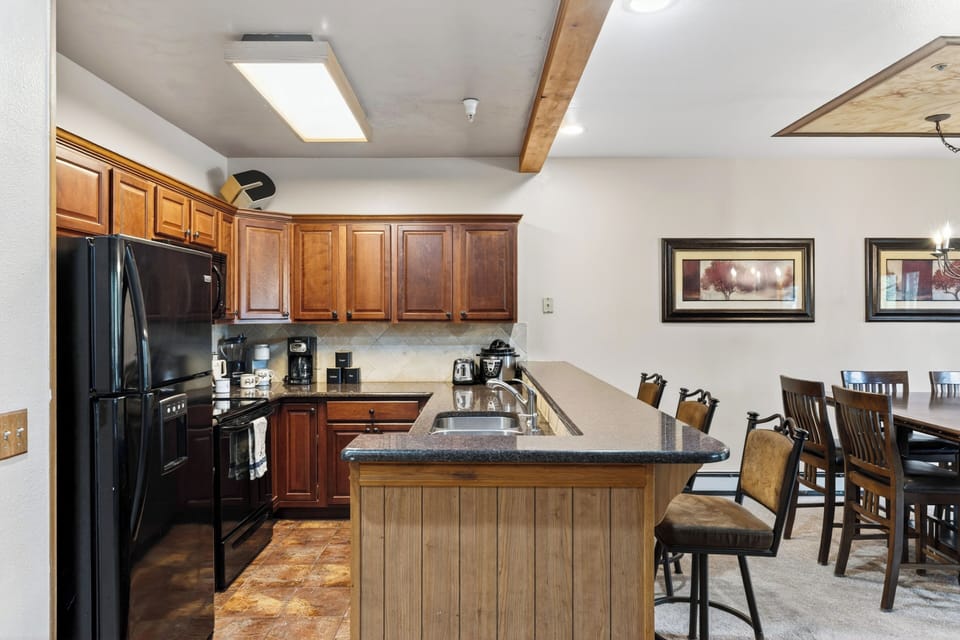 Spacious kitchen with breakfast bar seating and everything you need for easy group meals.