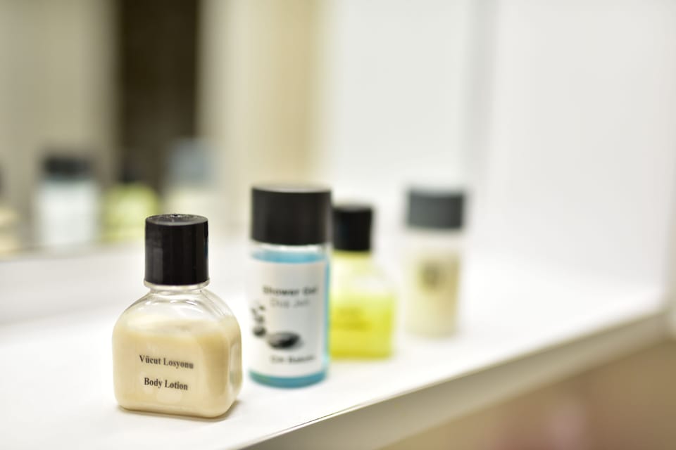 Classic Studio Suite, Balcony, Garden View | Bathroom amenities | Shower, hair dryer, slippers, towels