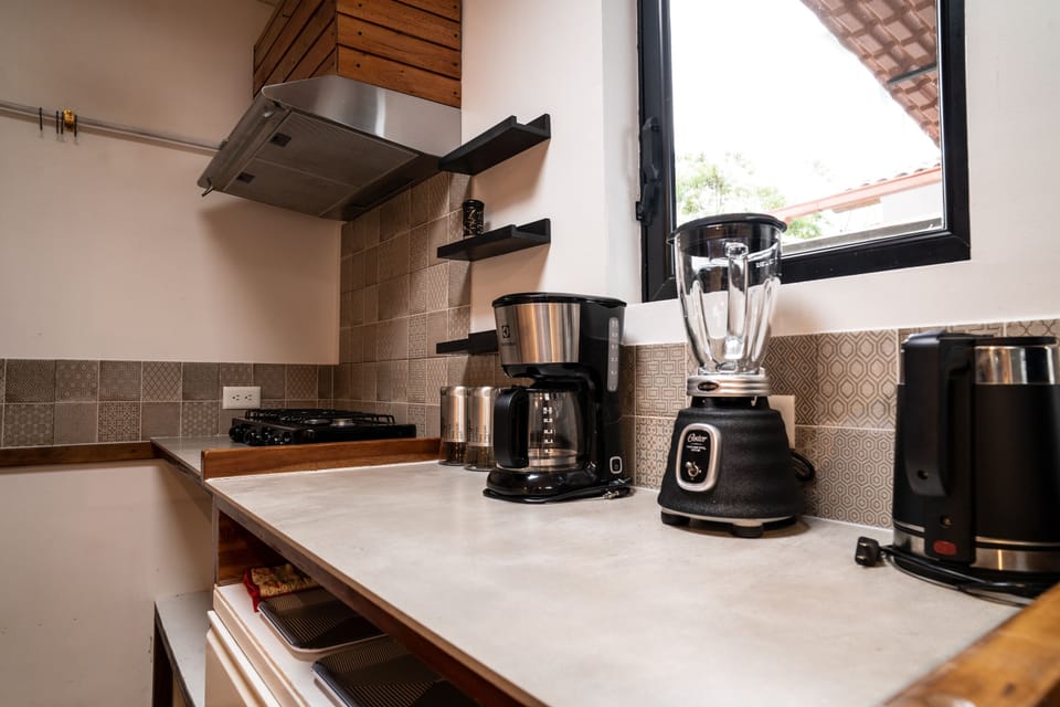 Deluxe Studio, 1 Queen Bed, Kitchen | Private kitchen | Highchair