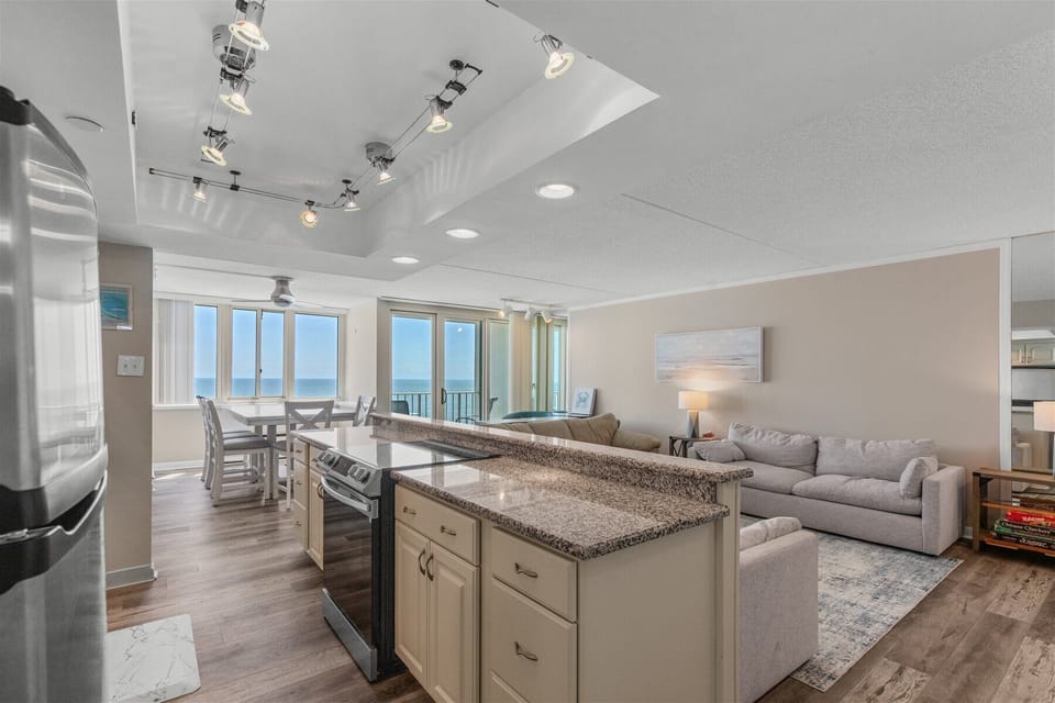 The massive kitchen island features an expansive breakfast bar, offering plenty of seating for snacks or morning coffee.