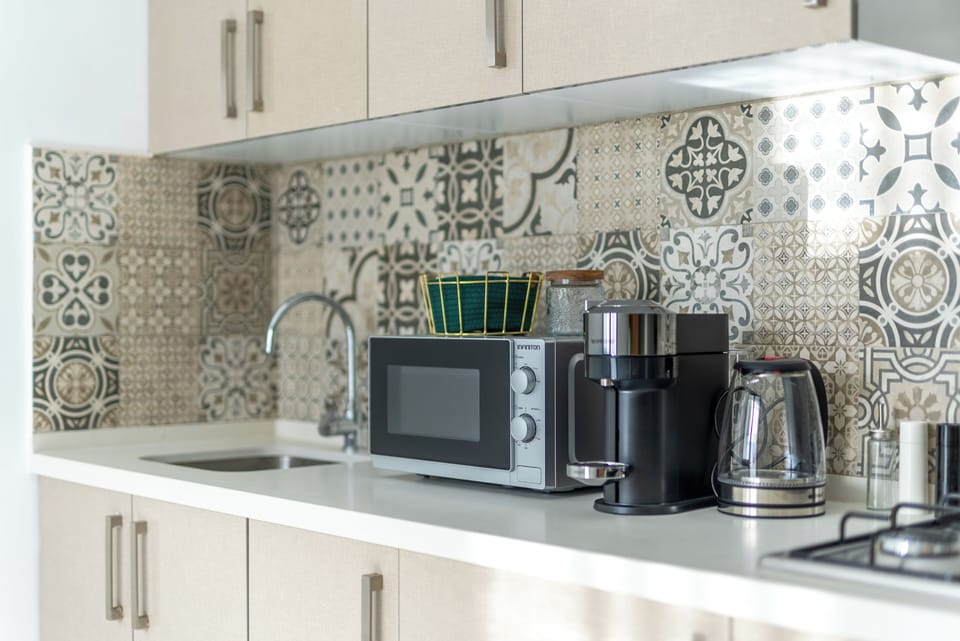 Apartment, Balcony, City View | Private kitchen | Espresso maker, coffee/tea maker