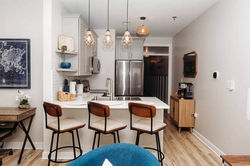 Whip up a quick meal in this renovated kitchen, complete with stainless steel appliances, quartz countertops, and all the essentials. Enjoy casual dining at the breakfast bar with seating for three under stylish lighting. Includes dishwasher.

