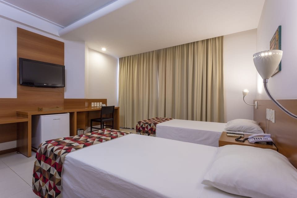 Standard Twin Room | Minibar, desk, laptop workspace, blackout drapes