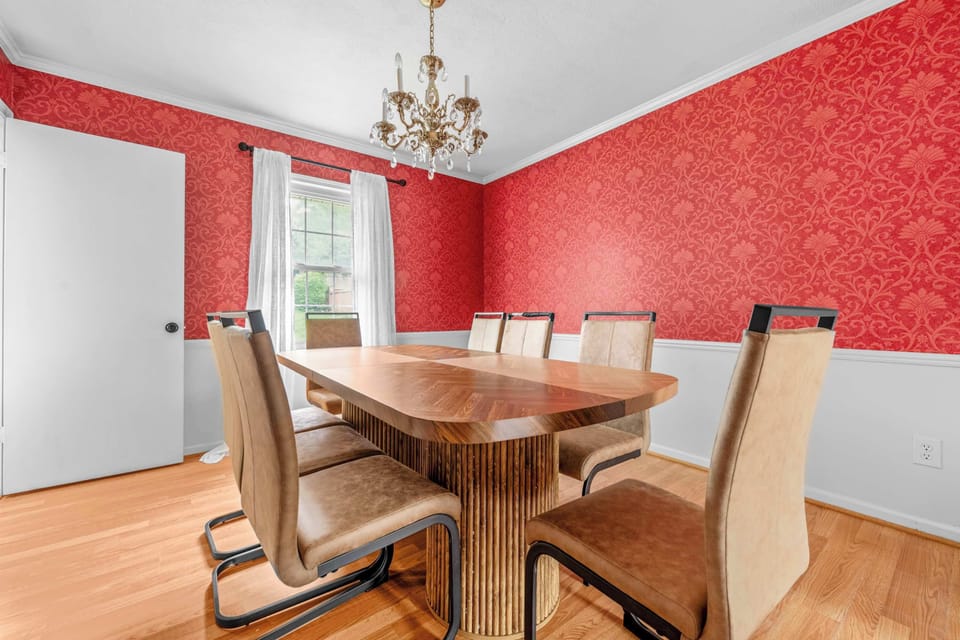 Take a peek through the arched entryway to spot a vibrant red patterned accent wall, hinting at the unique historic character blended into this freshly modernized property.