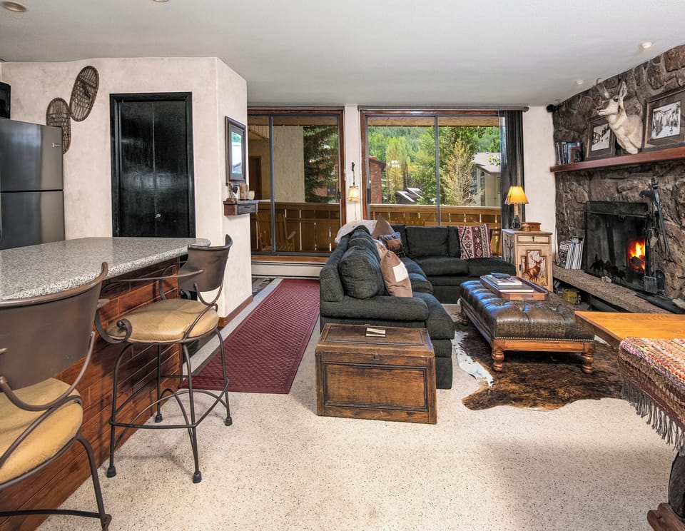 Unwind by the crackling stone fireplace, sink into plush seating with mountain views streaming through your windows, and let this cozy retreat become your home away from home.