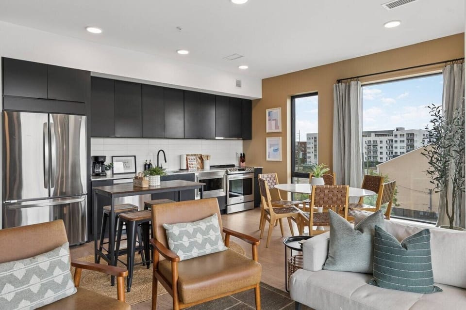 Open concept from the living room to the fully equipped kitchen with high-end appliances and two dining areas. Private balcony off of this area to enjoy your morning coffee.