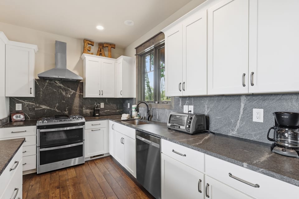 Bright modern kitchen featuring stainless steel appliances, stylish finishes, and an open layout that flows effortlessly into the living space — perfect for cooking and gathering.