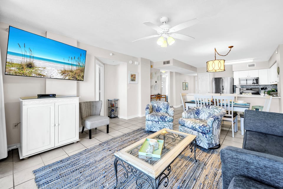 Unwind in this breezy coastal living space, where plush seating and a large TV invite you to relax after sun-soaked beach days. Your vacation haven awaits.