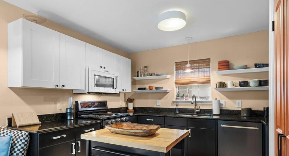 Cook like a local in the full kitchen with granite counters, floating shelves, and a butcher-block island.
