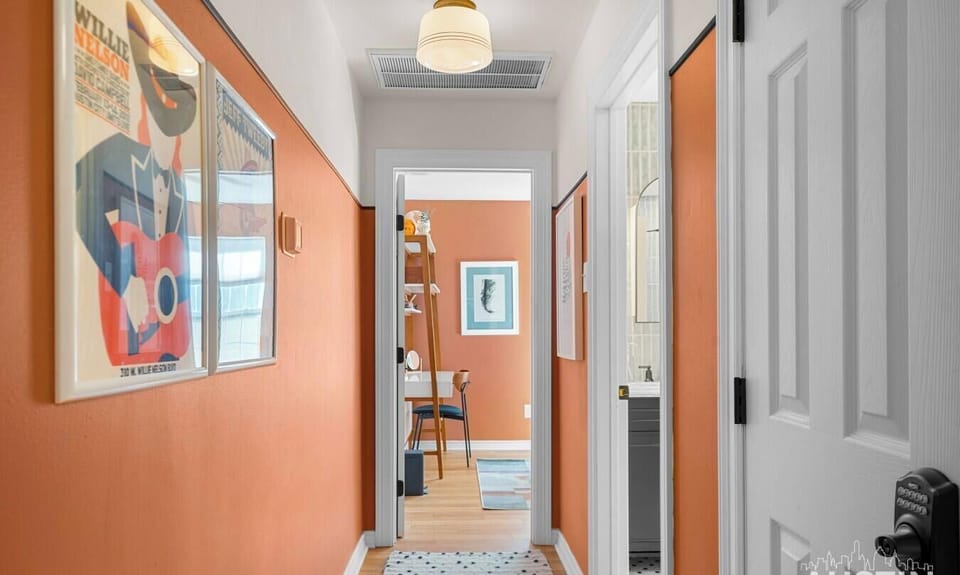A terracotta hallway leads to a bedroom workspace and full bath, with keyless entry for added privacy.