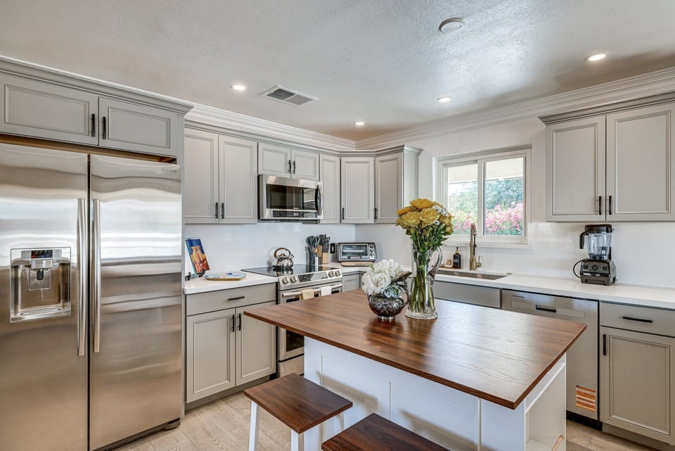Bright and functional kitchen awaits, perfect for whipping up meals with modern appliances and a cozy dining nook.