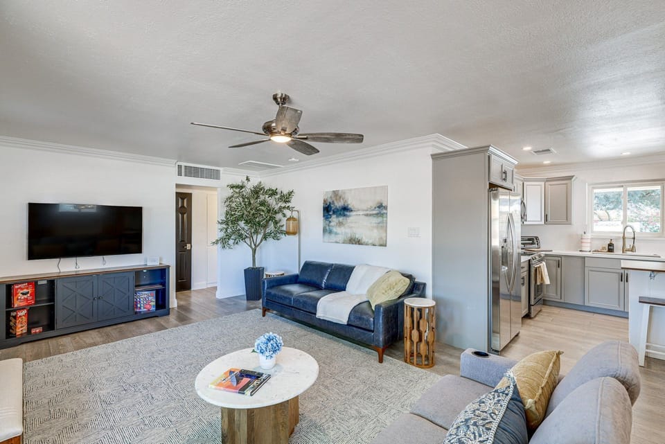 Gather with friends and family in this stylish living space, featuring a sleek kitchen and modern decor.