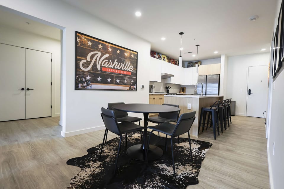 Spacious dining space featuring a modern table setup and fully equipped kitchen with island seating