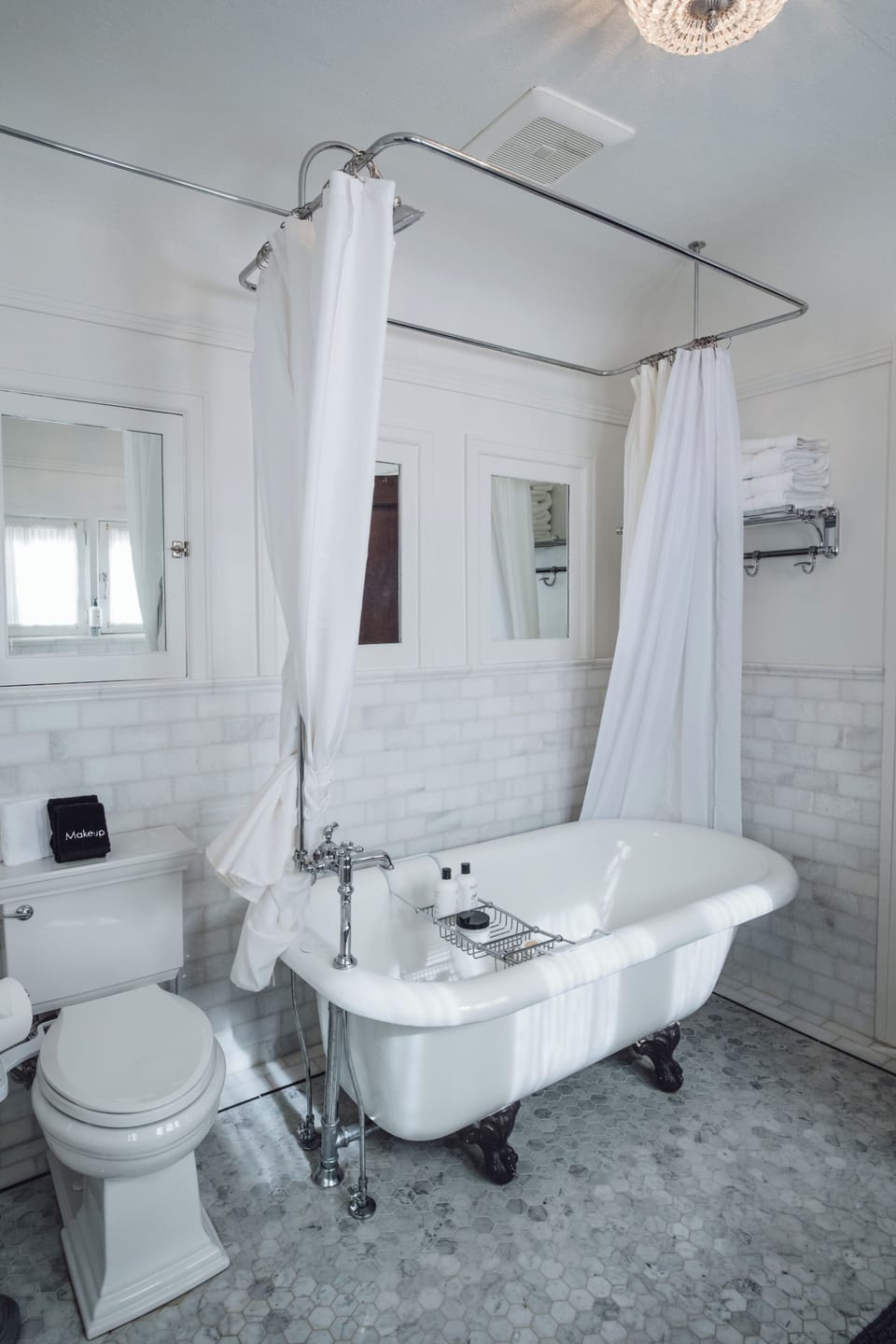 Elegant clawfoot tub in a bright, spa-like vintage bathroom