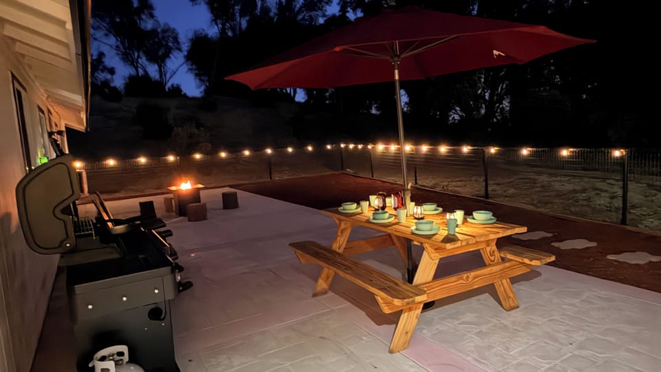 Dine under the stars with firelight, cozy seating, and mountain views.