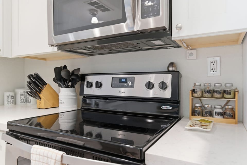 Gather in the bright, open kitchen with stainless steel appliances and a breakfast bar, perfect for morning coffee, easy meals, and happy-hour bites.