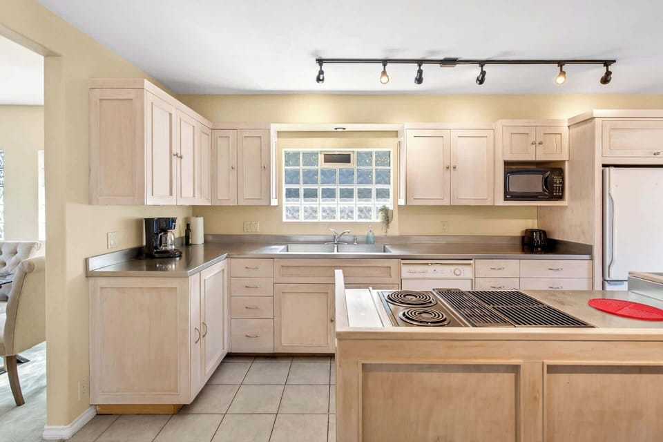 Well appointed kitchen with extensive counter space, light wood cabinetry, and a bright open feel.