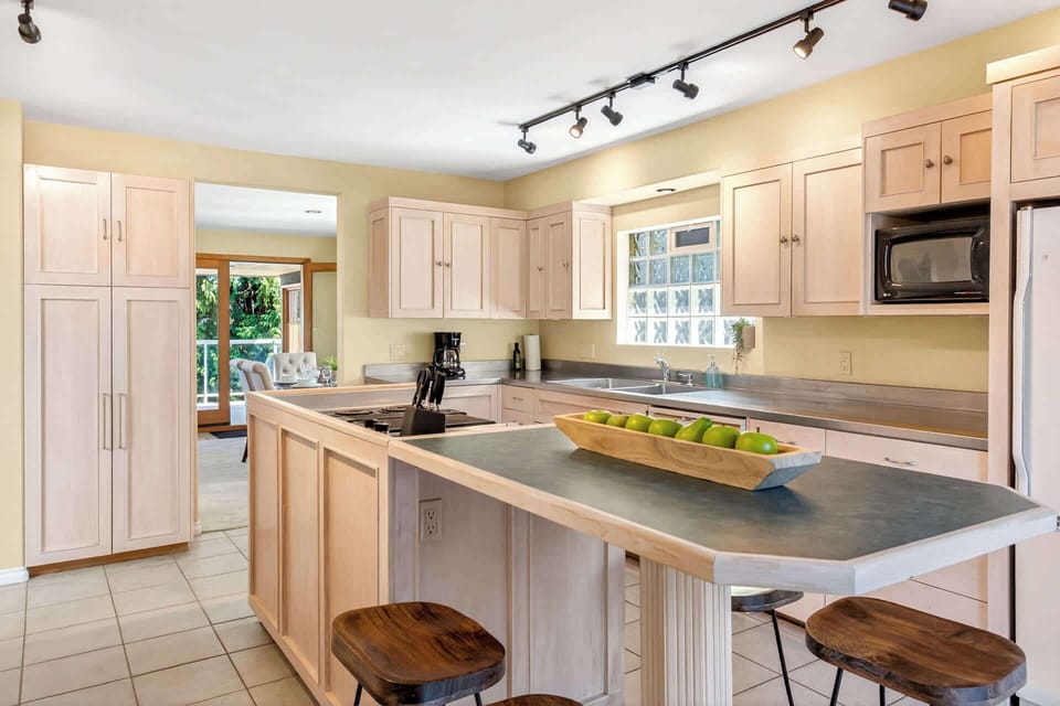 Fully equipped kitchen with a central island, bar seating, and plenty of space for cooking and gathering.