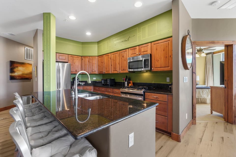 Fully equipped kitchen with gas range, granite countertops, and plenty of space to prepare meals