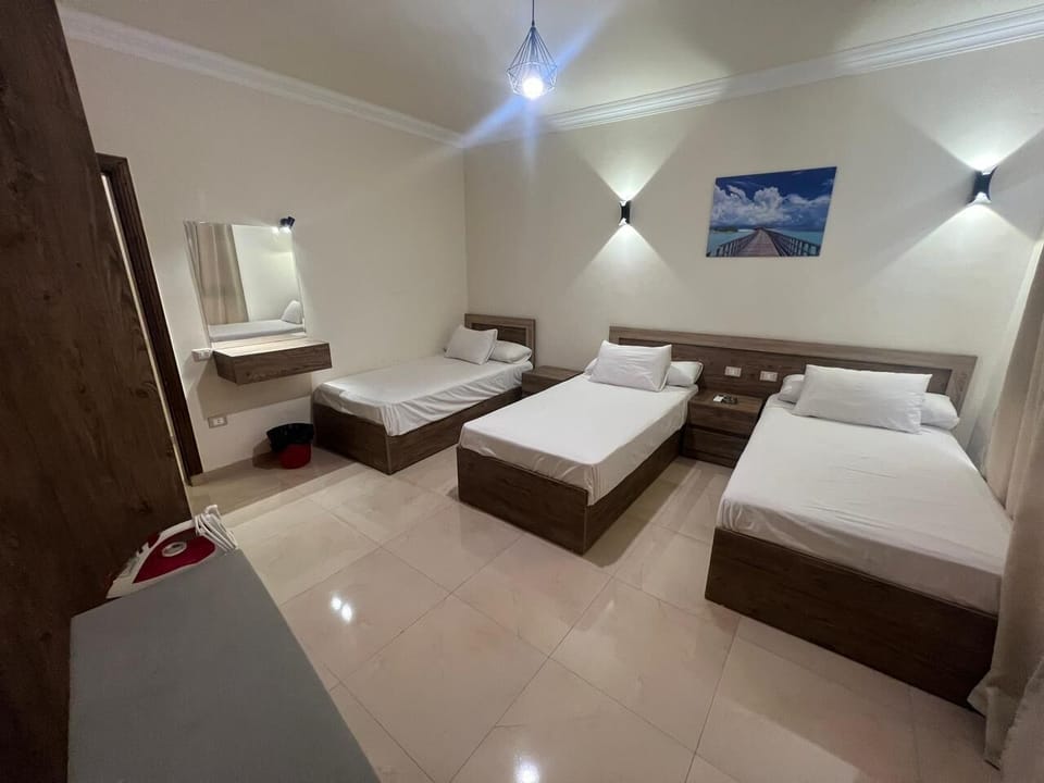 Deluxe Apartment, City View | Desk, blackout drapes, iron/ironing board, bed sheets