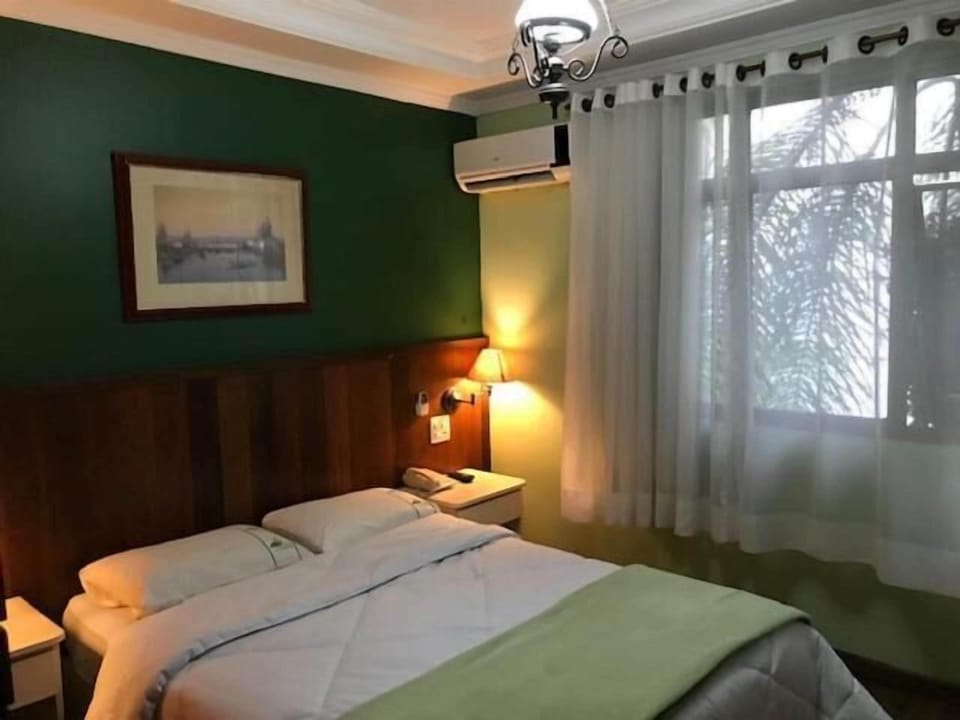 Standard Double Room | Minibar, desk, blackout drapes, iron/ironing board