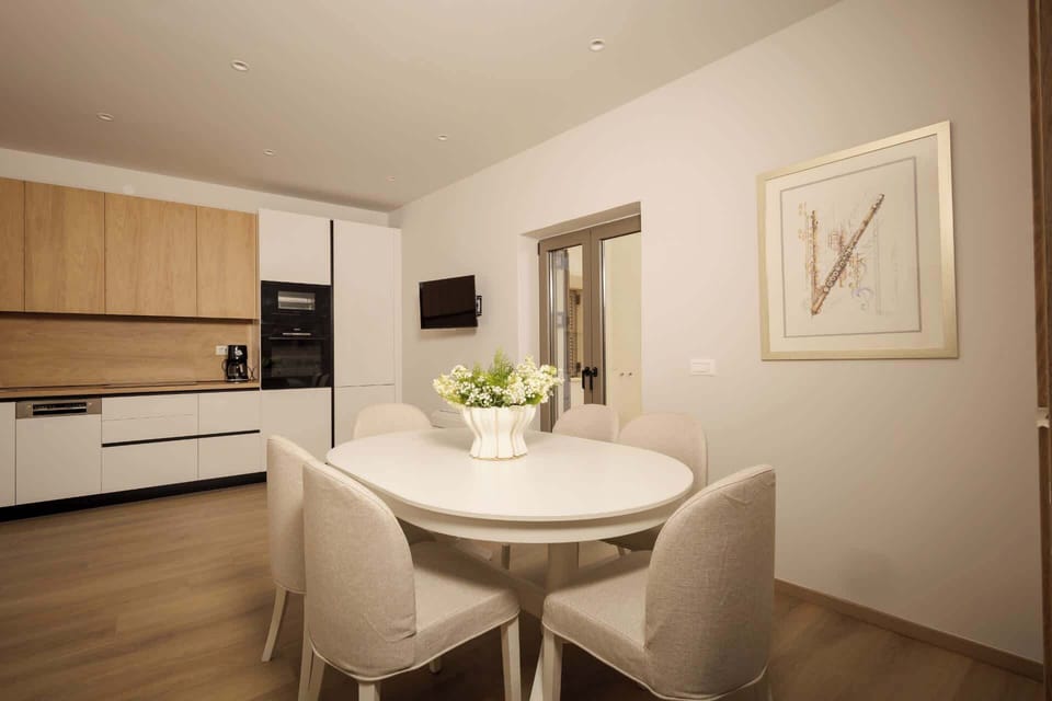 Share meals or enjoy a quiet evening indoors in this bright dining area designed with comfort, simplicity, and modern Mediterranean style