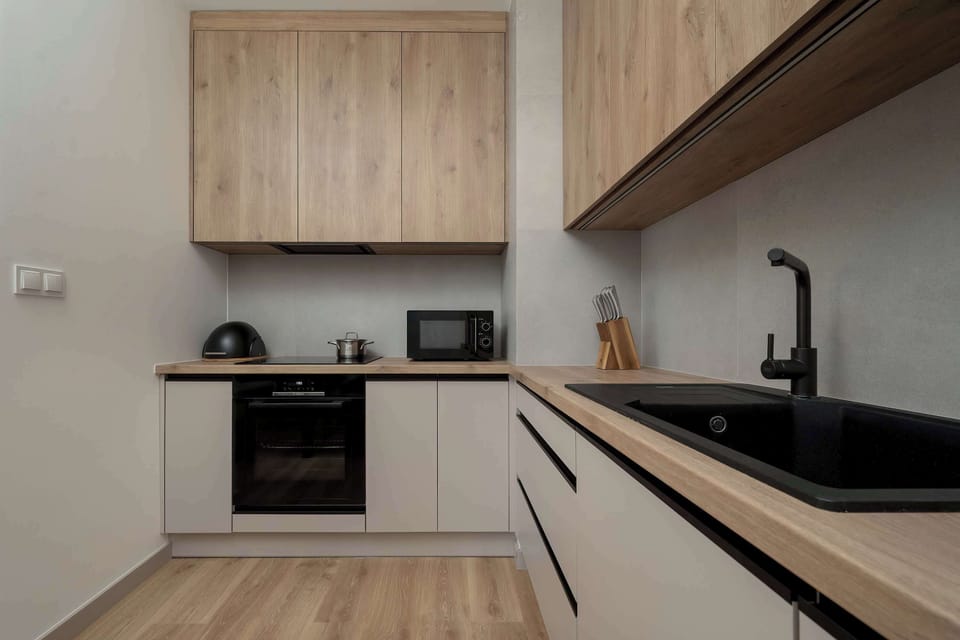 Contemporary kitchen with integrated appliances, wooden cabinetry, and a practical layout.