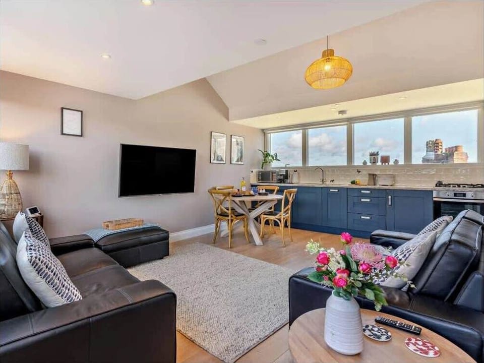 Comfortable lounge with fully equipped kitchen and dining area.