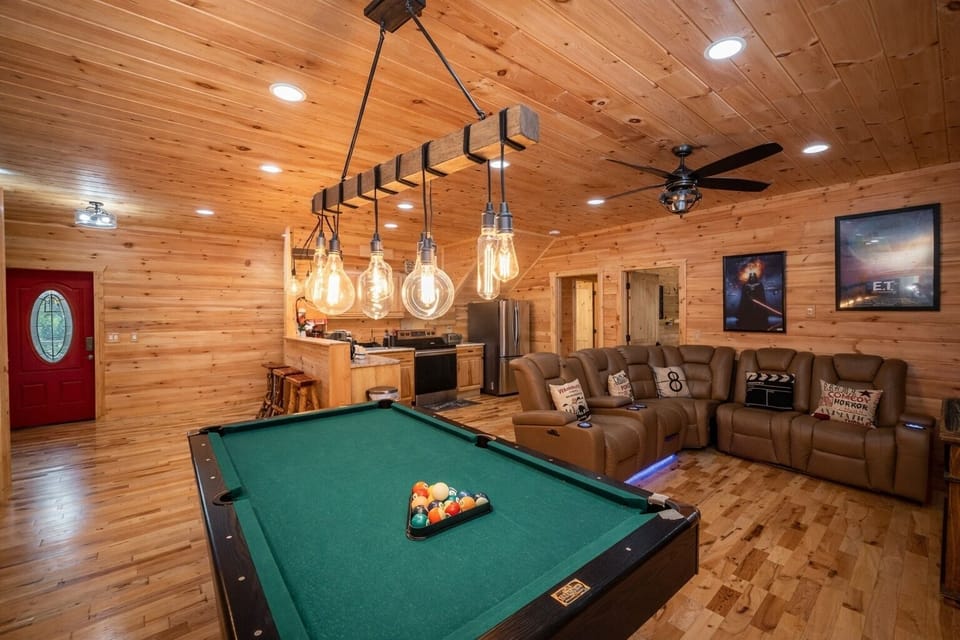 A theater room including a pool table and bar for guaranteed fun!