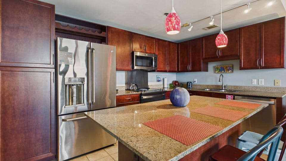 Fully applianced kitchen with island and breakfast seating. Equipped with all the cooking essentials for your stay.