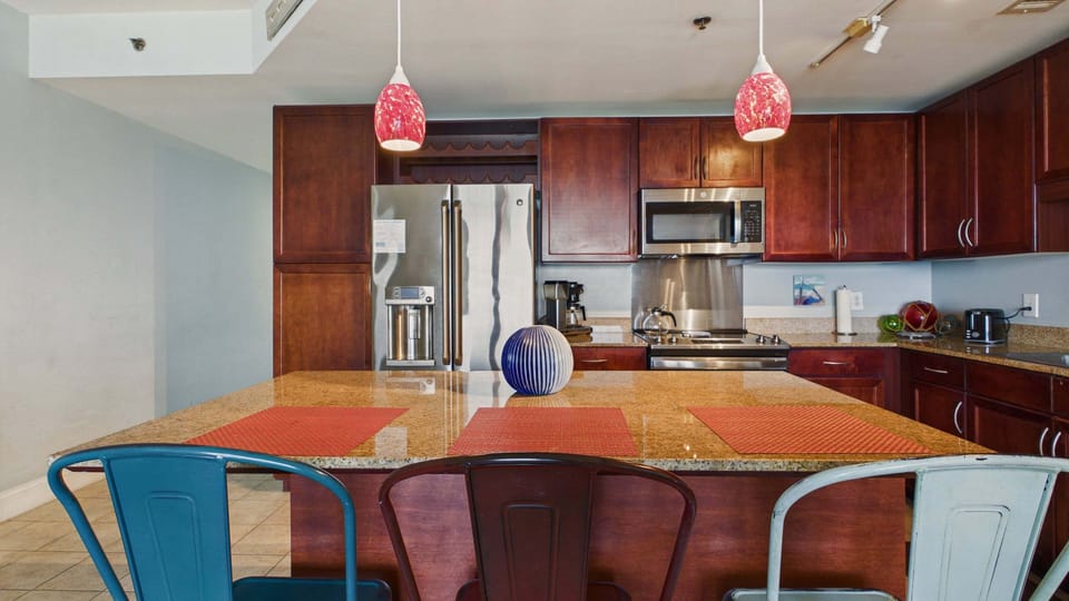 Fully applianced kitchen with island and breakfast seating. Equipped with all the cooking essentials for your stay.