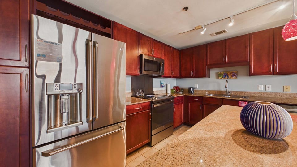 Fully applianced kitchen with island and breakfast seating. Equipped with all the cooking essentials for your stay.