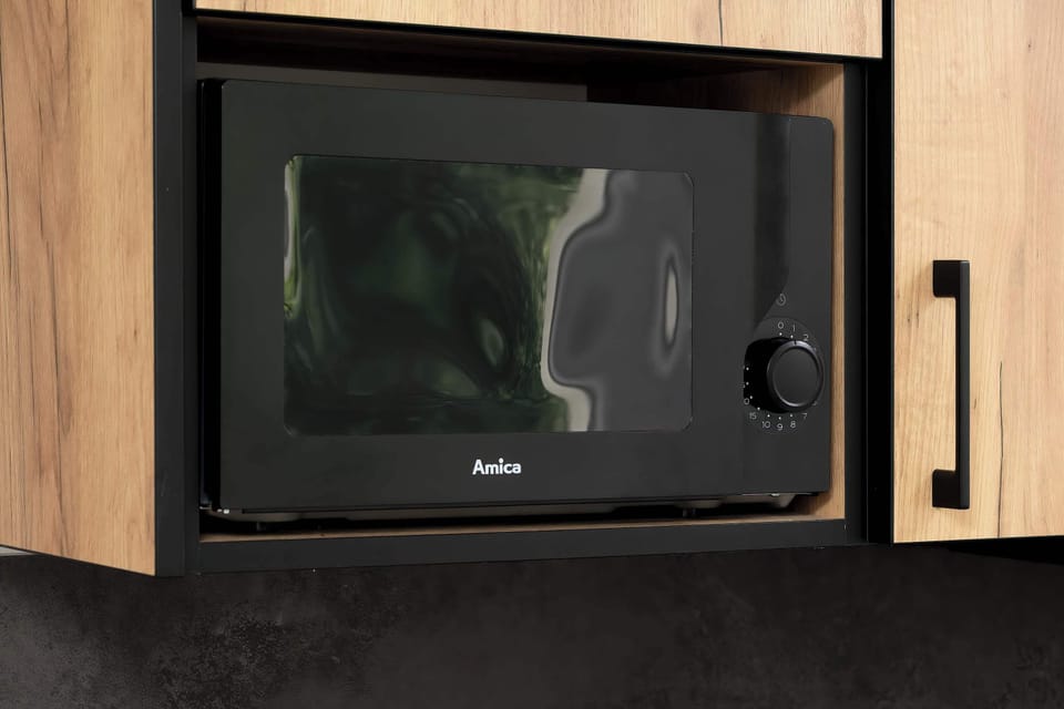 Built-in microwave and contemporary kitchen finishes for maximum convenience.