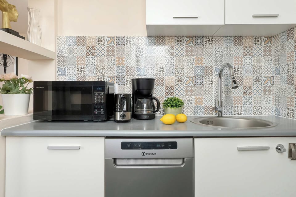 Fully equipped cooking area with coffee machine, kettle, and essential kitchen amenities.