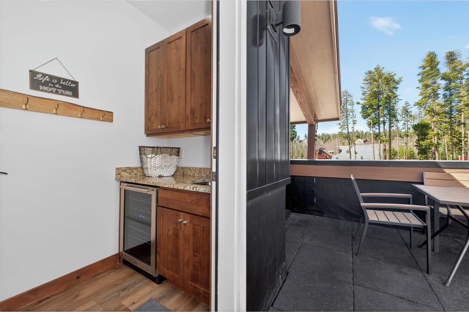 Seamlessly flow from your modern kitchenette to your private balcony, where forest views create the perfect backdrop for morning coffee or evening dining.
