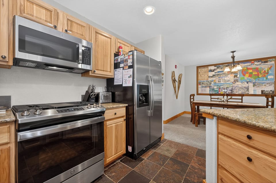 Your fully equipped kitchen features stainless steel appliances, ample counter space, and a cozy dining nook—perfect for preparing meals and gathering with family after a day of mountain adventures.