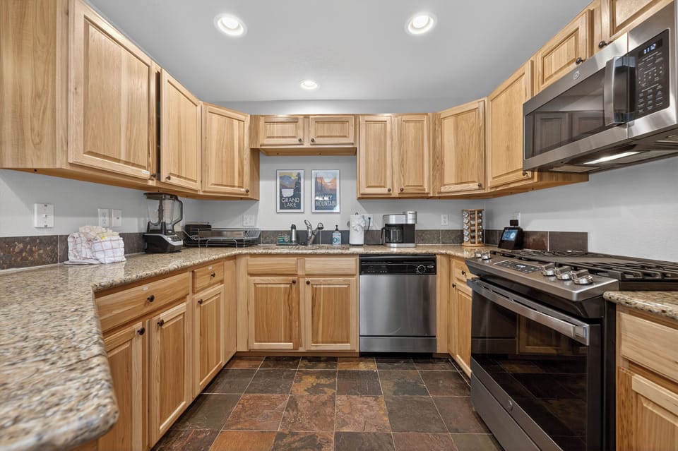 Your fully equipped kitchen features ample counter space, modern appliances, and warm wood cabinetry—perfect for preparing home-cooked meals during your stay.