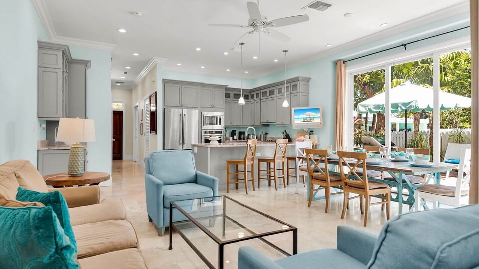 The open floor plan and floor-to-ceiling glass sliders, create a light and airy atmosphere in the living area...