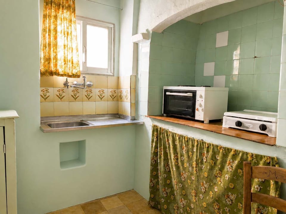 A practical kitchen space designed for convenience and efficiency. Bright natural light, useful storage, and essential appliances make this area well suited for preparing meals while maintaining a clean and organized environment