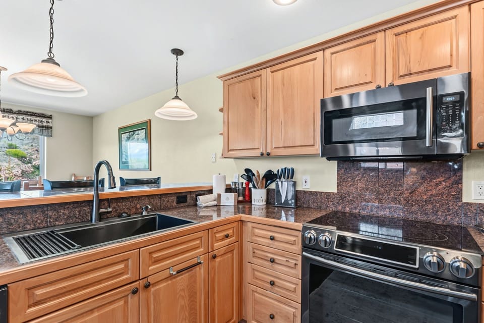 Your vacation kitchen awaits with granite countertops, full appliances, and ample cabinet space—perfect for preparing meals together or enjoying morning coffee with a view.
